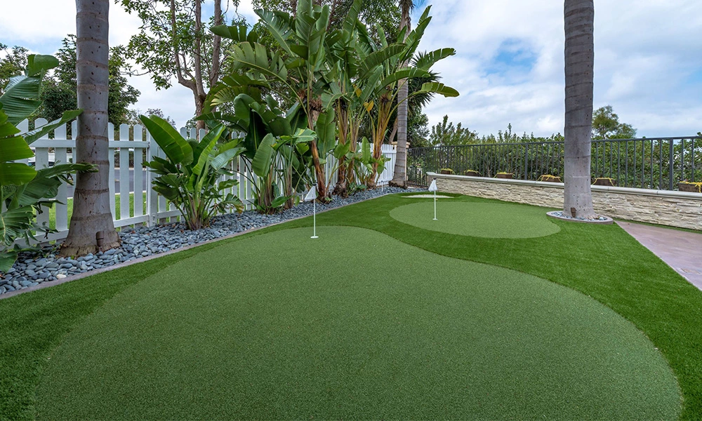 Why do golf courses use artificial grass?