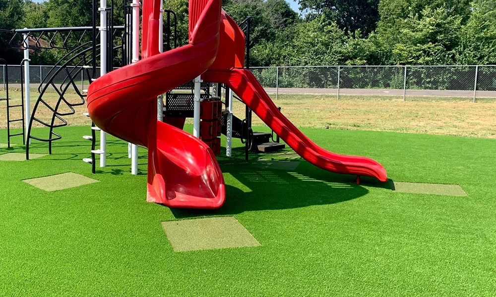 Why is artificial turf suitable for playgrounds?