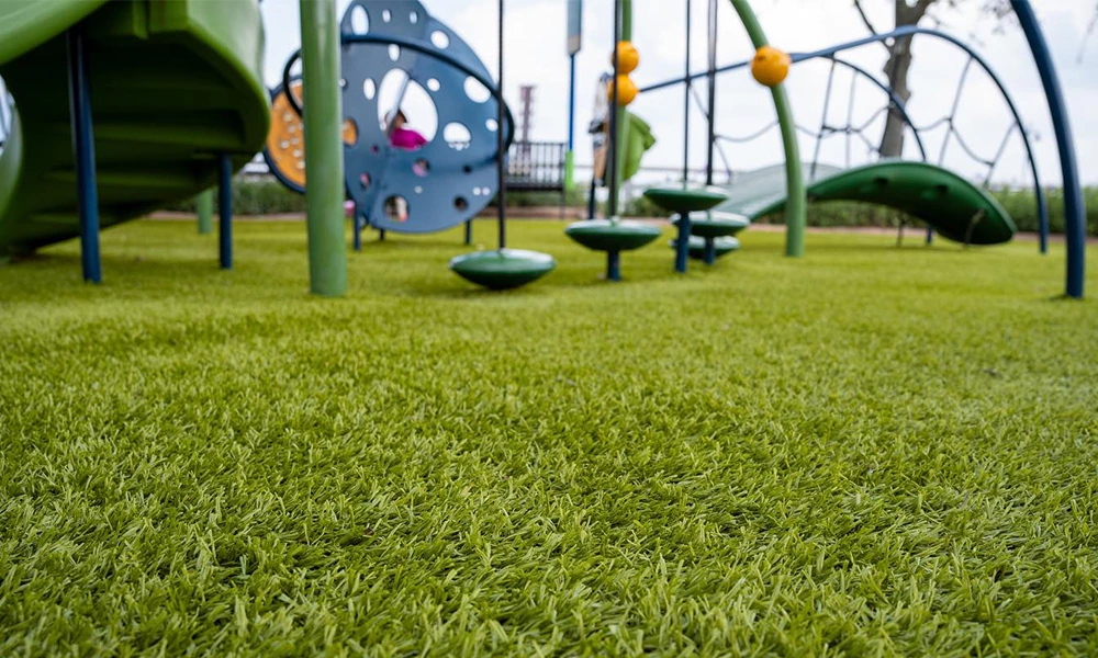 Why is artificial turf suitable for playgrounds?